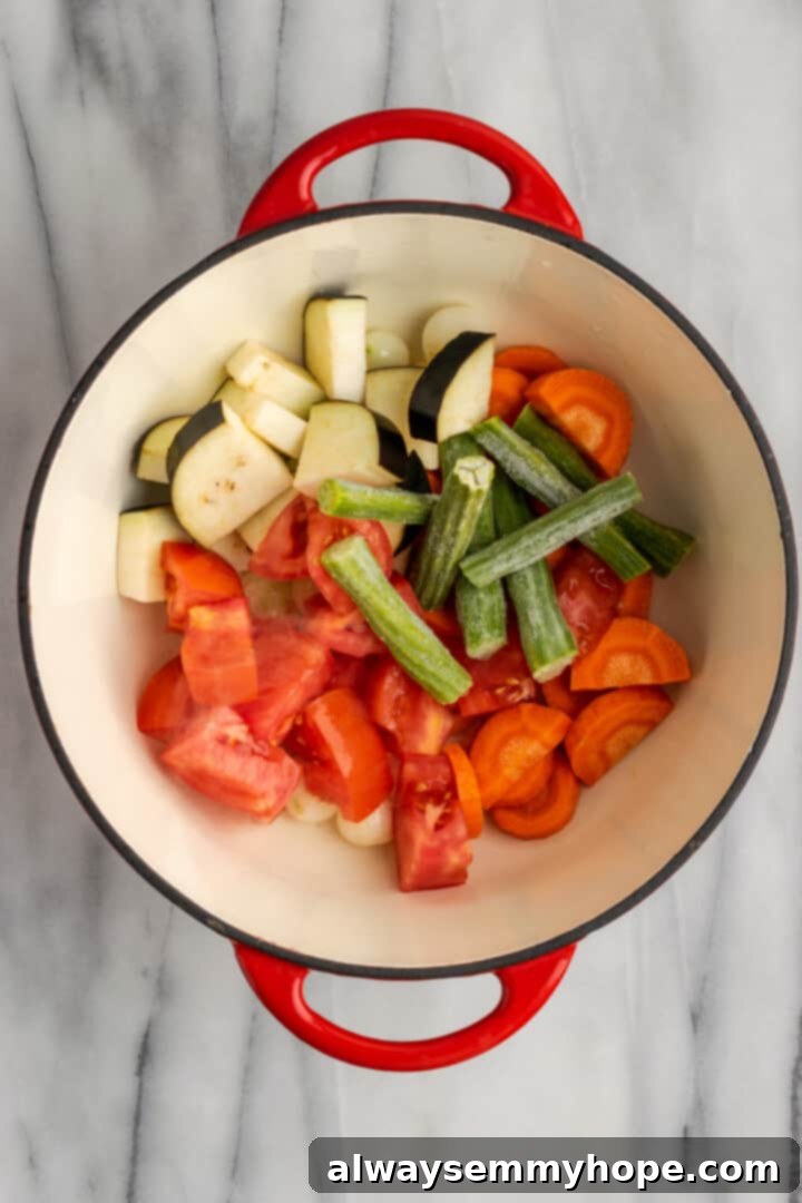 This vegan sambar is just like the sambar at your favourite Indian restaurant! Here's how to make this hearty lentil and veggie stew at home. Overhead view of uncooked vegetables in Dutch oven