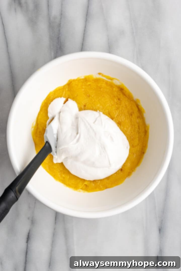 Folding vegan whipped topping into chilled banana pudding