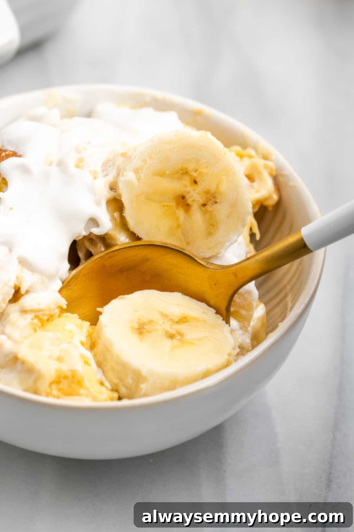 Spoon digging into creamy vegan banana pudding in a bowl