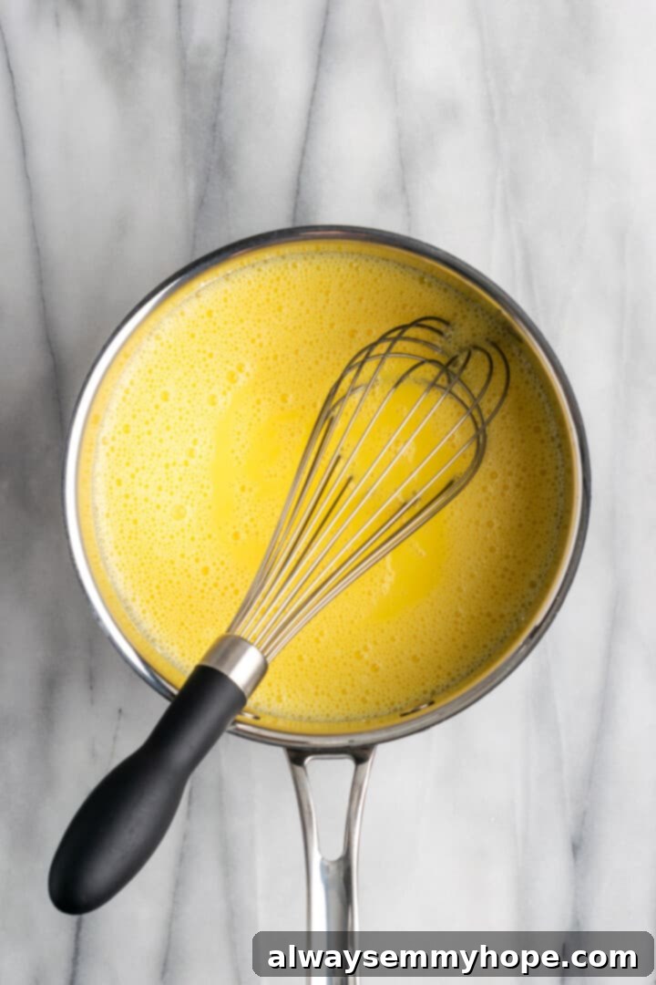 Whisking vanilla pudding in saucepan over medium heat