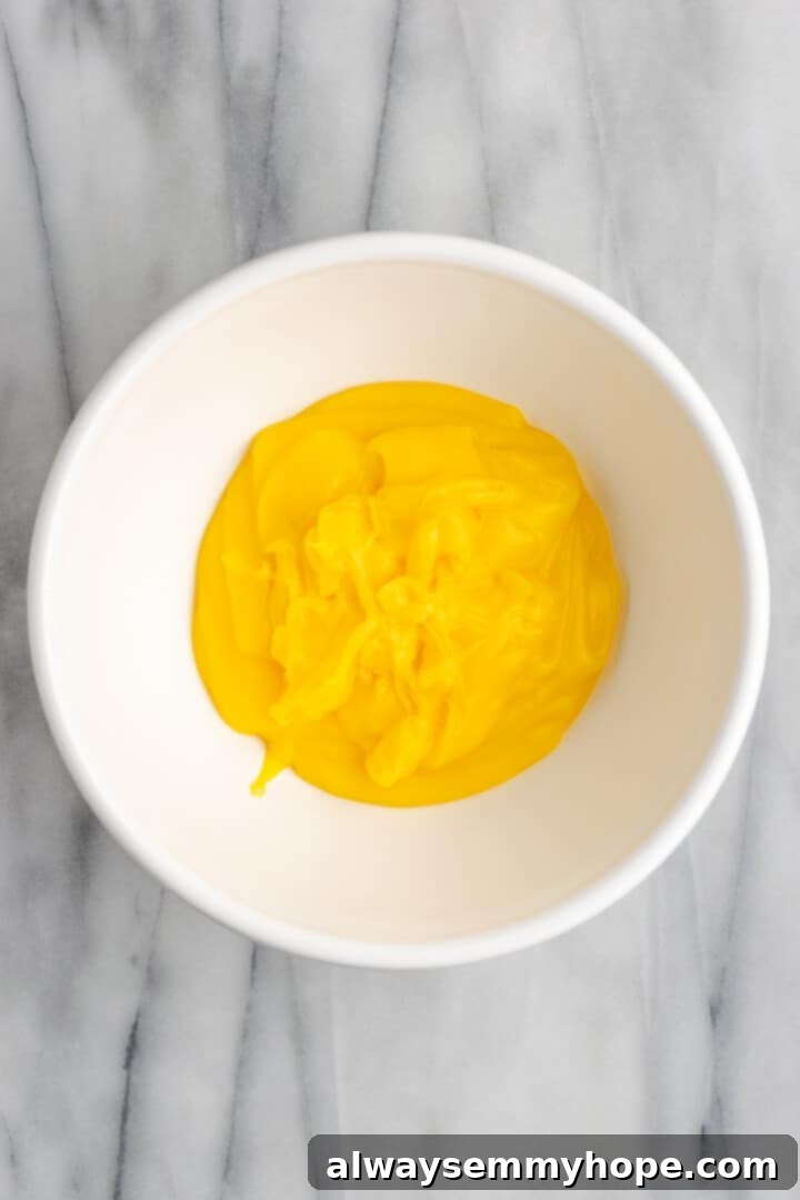 Warm vanilla pudding transferred to a mixing bowl