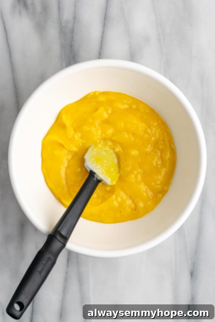 Banana pudding in a mixing bowl after folding, showing a smooth and consistent texture