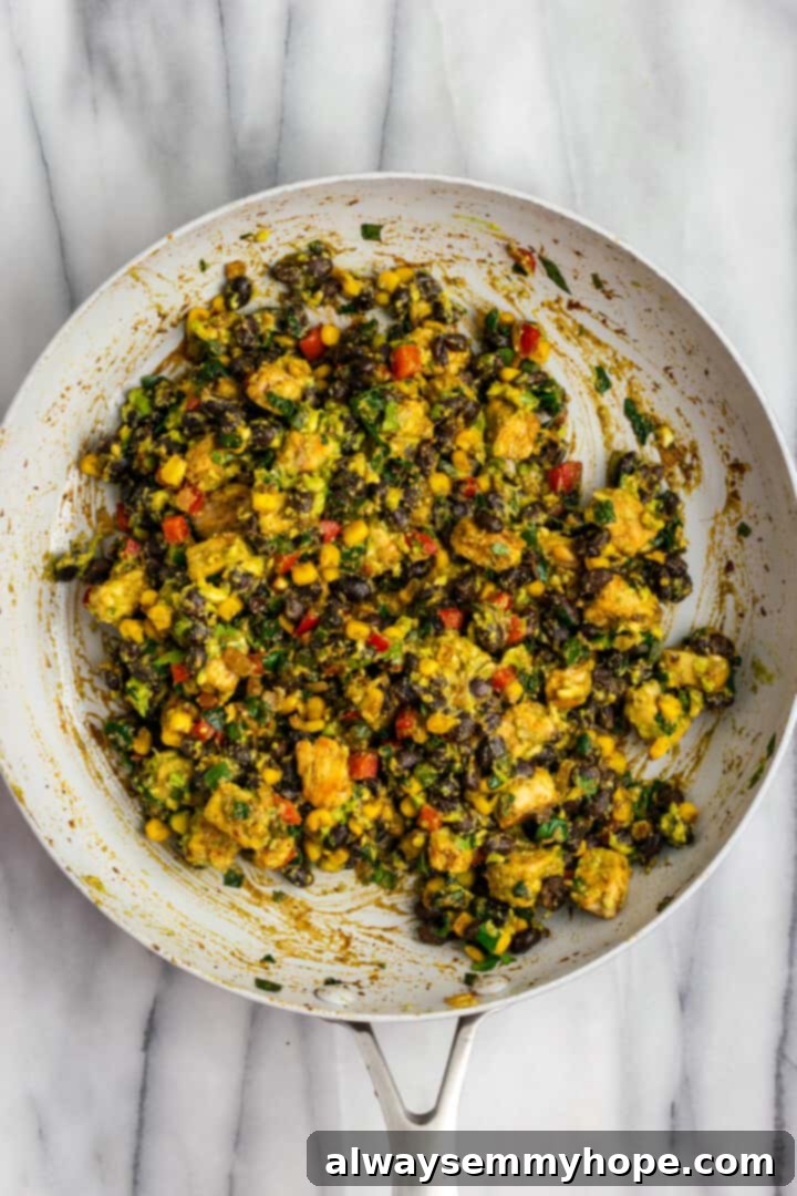 These crispy vegan southwest egg rolls are full of bold flavors and satisfying ingredients like vegan chicken, black beans, and veggies. Yum! Overhead view of filling for vegan southwest egg rolls