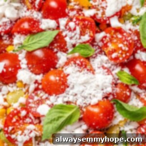 Closeup of vegan corn succotash with vegan feta, cherry tomatoes, and basil