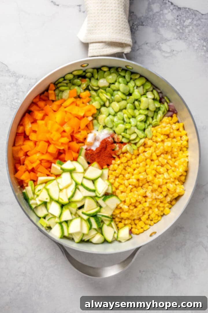 Overhead view of ingredients for corn succotash in skillet