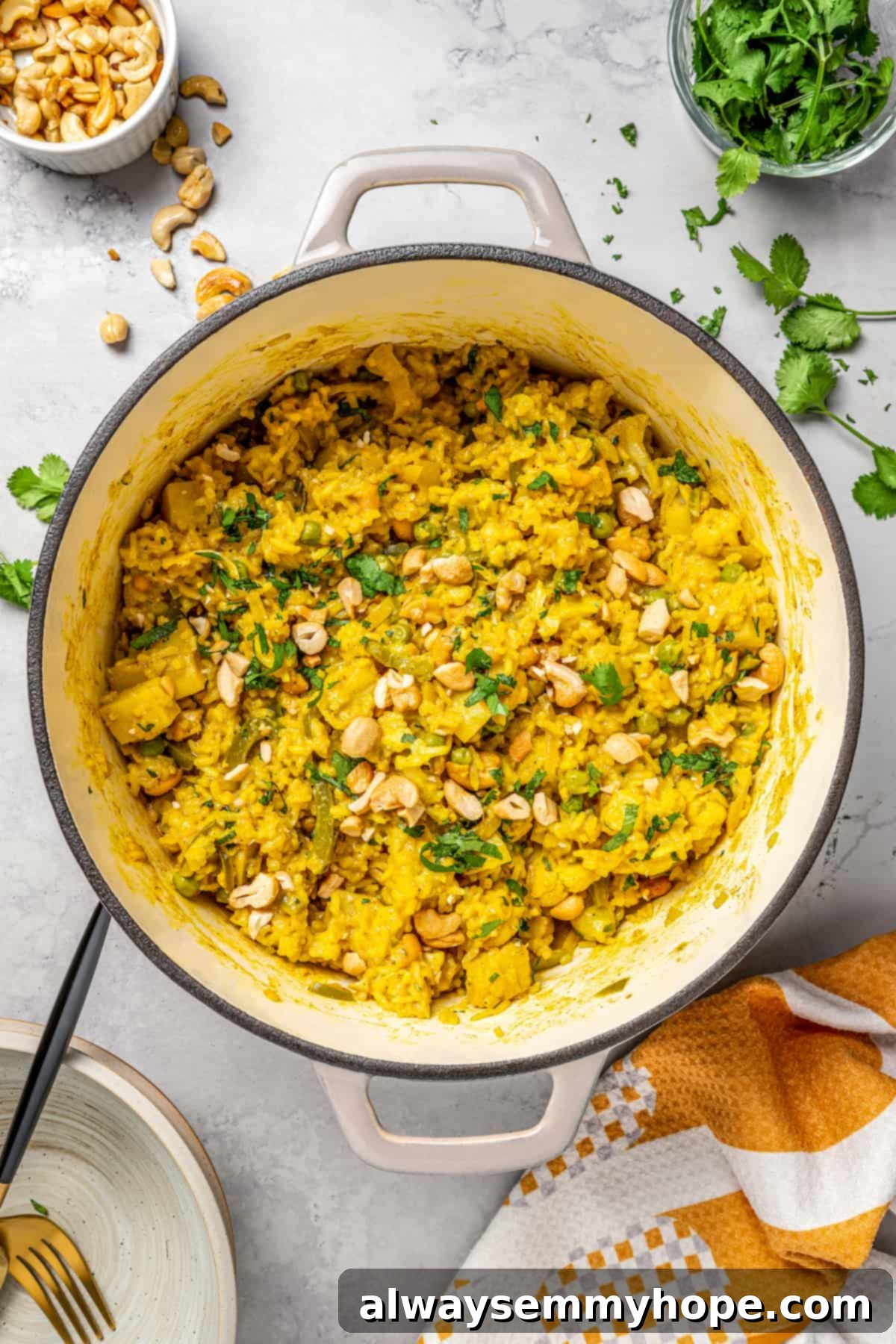 Steaming Pot of Freshly Cooked Vegan Vegetable Biryani A large pot of vibrant vegan vegetable biryani, generously topped with toasted cashews and fresh cilantro, steaming gently.