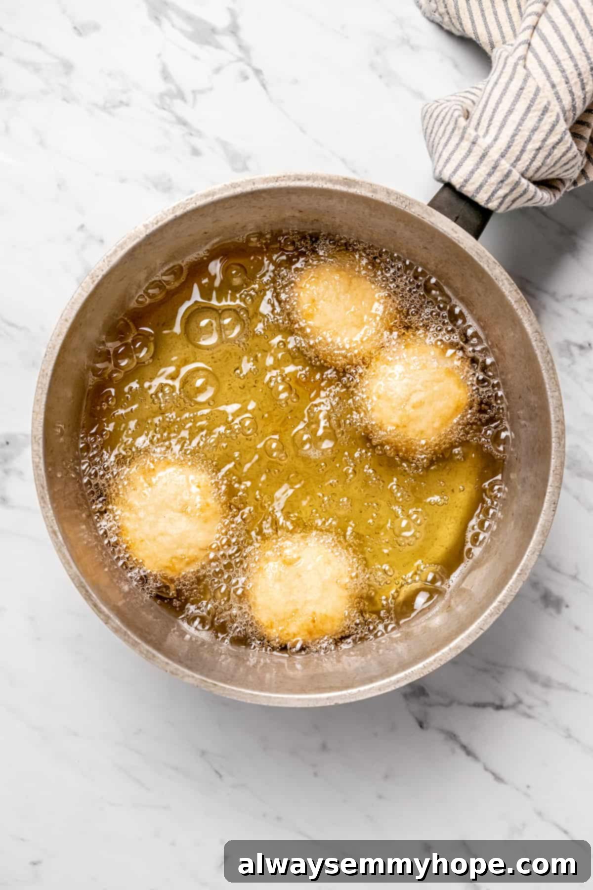 Overhead view of dumplings cooing in oil