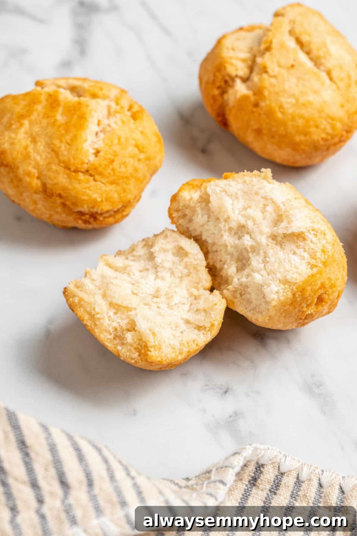 Vegan Jamaican fried dumplings on countertop, with one torn to show soft interior