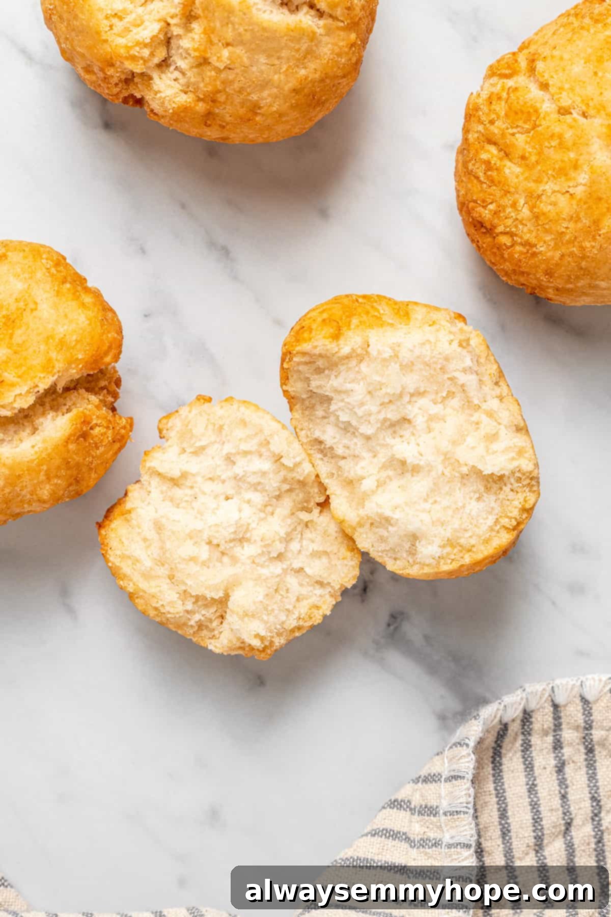 Vegan Jamaican fried dumplings on countertop, with one torn to show soft interior