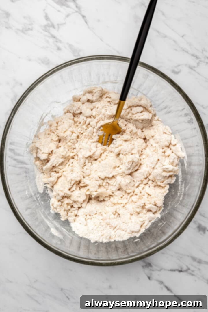 Overhead view of fork mixing dough for dumplings