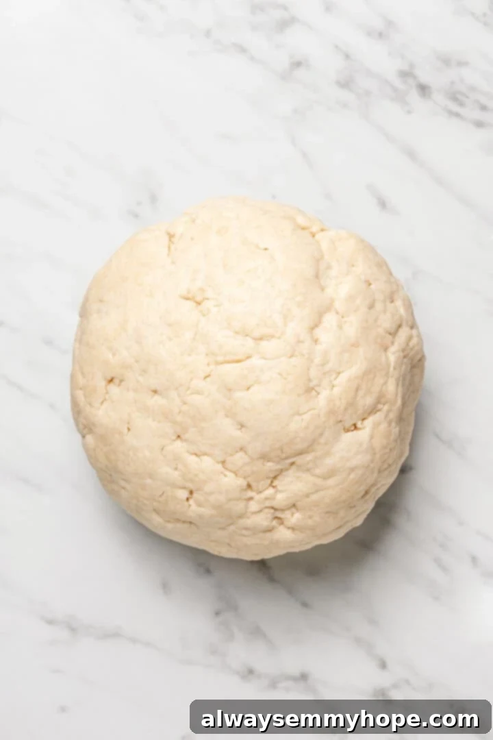 Overhead view of dough for Jamaican fried dumplings on marble countertop