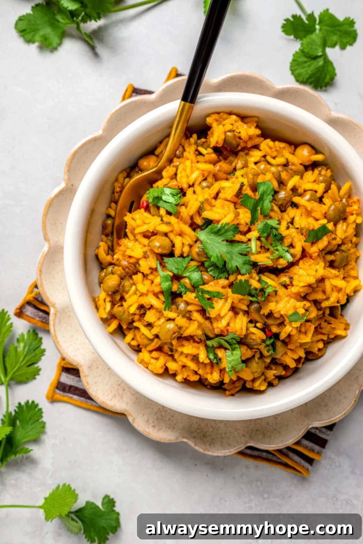 Overhead view of a single bowl of vegan Puerto Rican rice and beans with a fork, highlighting its rich textures and colors.