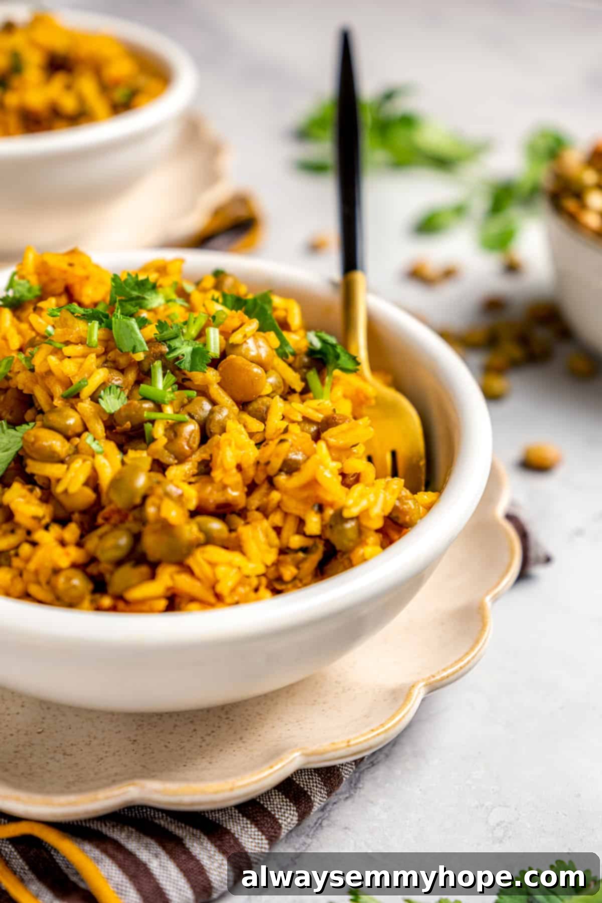 A vibrant bowl of Puerto Rican rice and beans with a fork, garnished with fresh cilantro.
