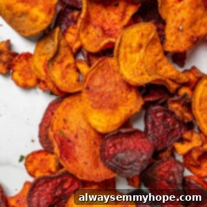 Overhead view of crispy air fryer veggie chips on marble countertop