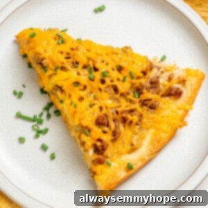 Plant-Powered Morning Pizza 2 Overhead view of vegan breakfast pizza slice on white plate, garnished with chives