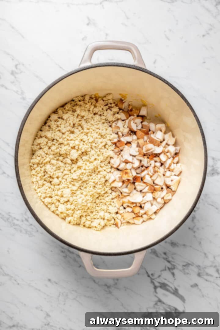 Overhead view of crumbled tofu and shiitakes in Dutch oven