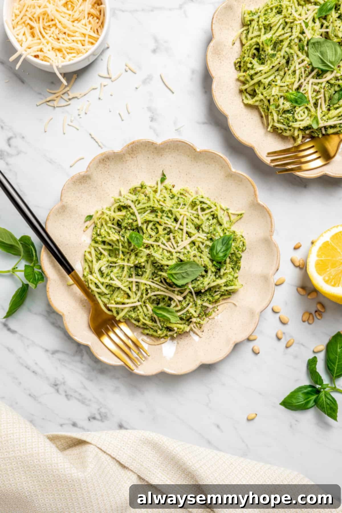 Overhead view of two plates of hearts of palm pasta with forks