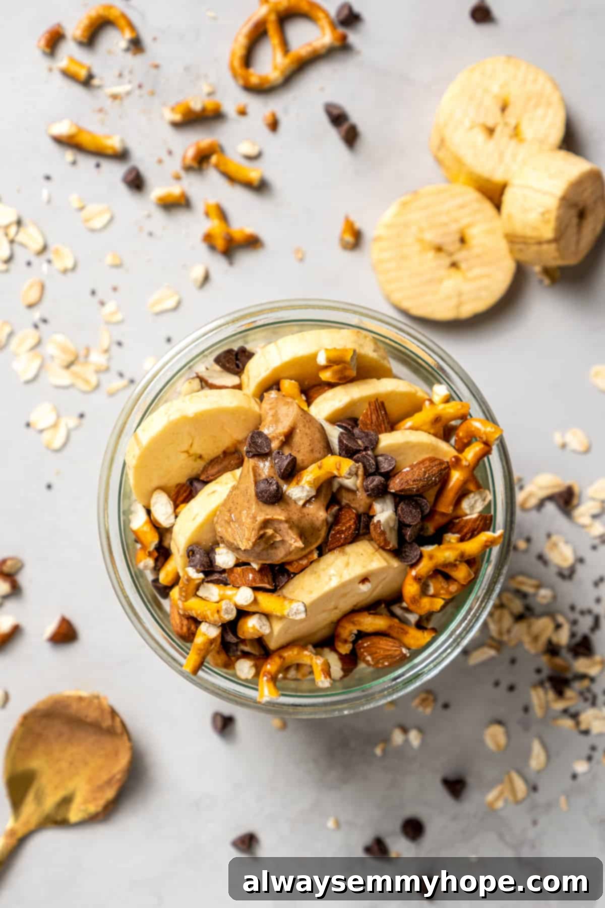 Fuel Your Day: Easy & Delicious Vegan High-Protein Overnight Oats (4 Flavors!) Almond butter pretzel high-protein overnight oats in glass jar