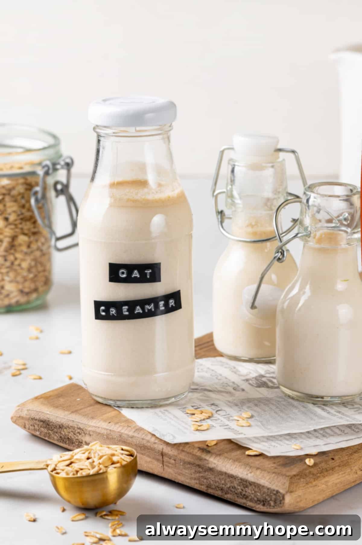 Three glass bottles of homemade oat milk coffee creamer, showcasing various flavors or sizes.