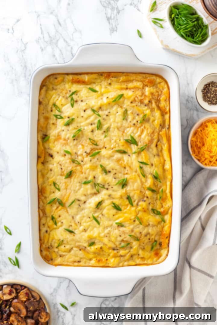 Love biscuits and gravy? You’re going to flip for biscuits and gravy casserole! The comfort food you love in a crowd-pleasing casserole. Overhead view of the finished baked vegan biscuits and gravy casserole, hot and bubbly, ready to serve