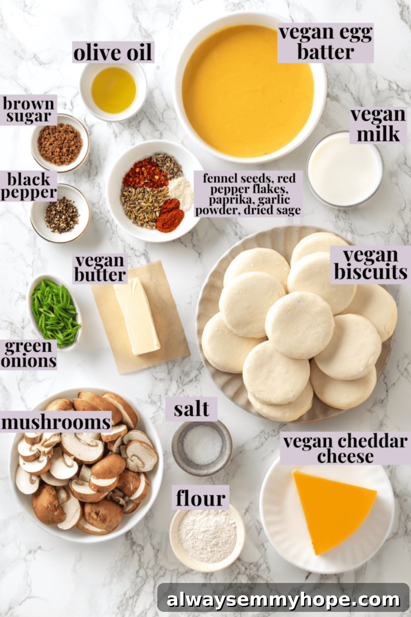 Love biscuits and gravy? You’re going to flip for biscuits and gravy casserole! The comfort food you love in a crowd-pleasing casserole. Overhead view of all the fresh ingredients for vegan biscuits and gravy casserole neatly arranged with labels, including mushrooms, plant milk, vegan cheese, and spices