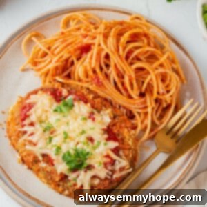 Overhead view of chicken parmesan on plate with spaghetti