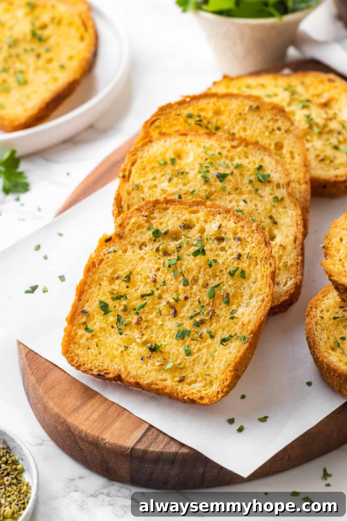 Slices of perfectly toasted vegan Texas toast arranged on a parchment-lined wooden board, ready to be enjoyed.