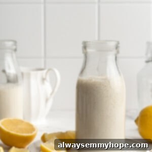 Plant-Based Buttermilk 2 Jar of vegan buttermilk on plate with lemons