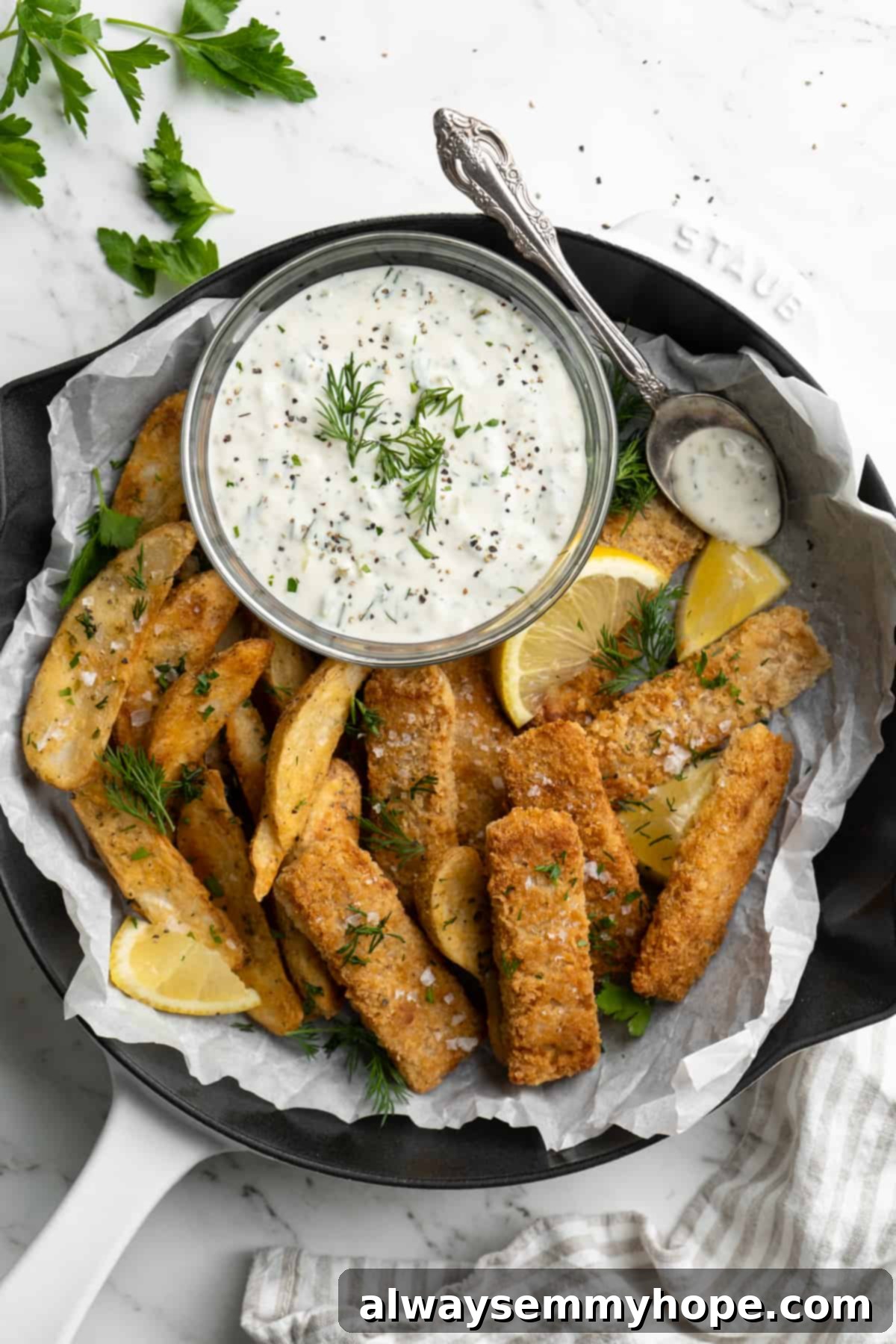 Overhead view of vegan tartar sauce with vegan fish and chips