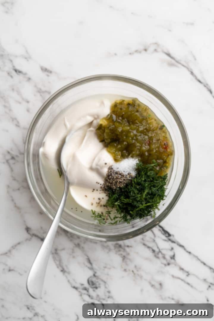 Overhead view of vegan tartar sauce ingredients in bowl with spoon