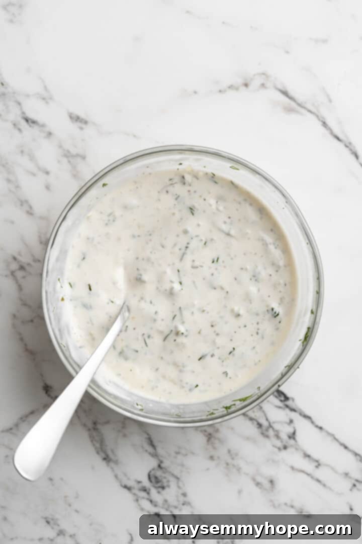 Overhead view of vegan tartar sauce in bowl with spoon
