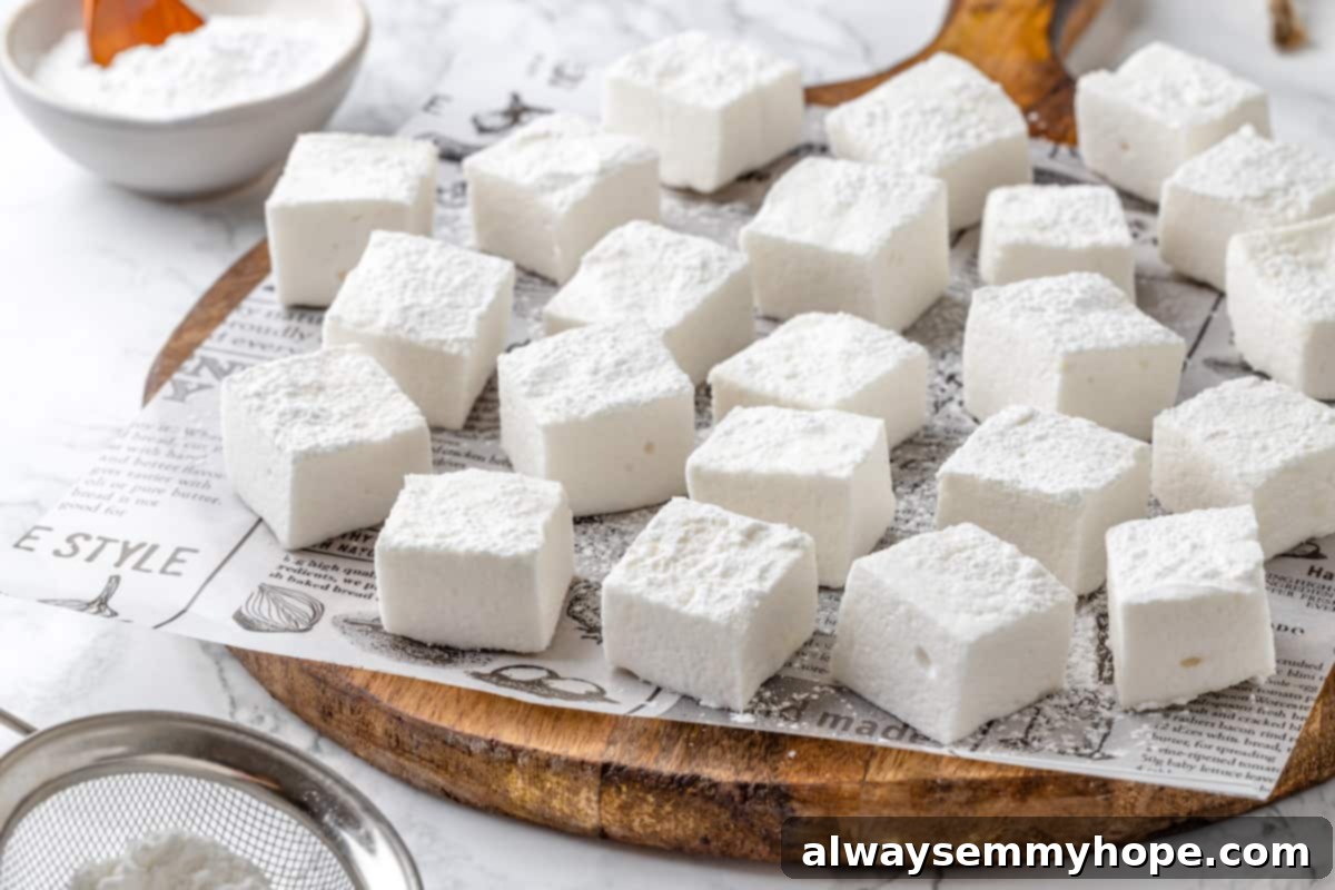 Vegan marshmallows arranged on newspaper-lined cutting board