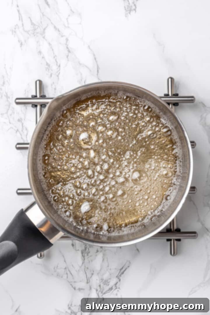 Overhead view of sugar syrup in saucepan