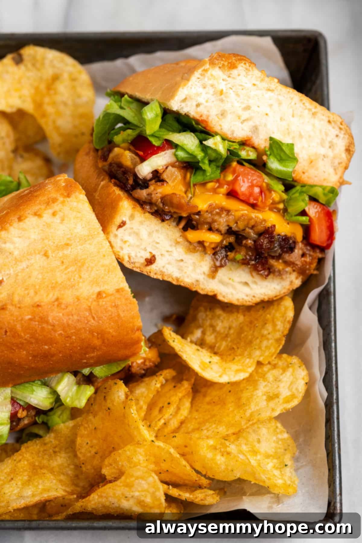 The chopped cheese sandwich is a NYC classic—and now you can make your own vegan version at home! You'll love this easy, delicious recipe. Top view of a sliced Vegan Chopped Cheese sandwich with a side of chips