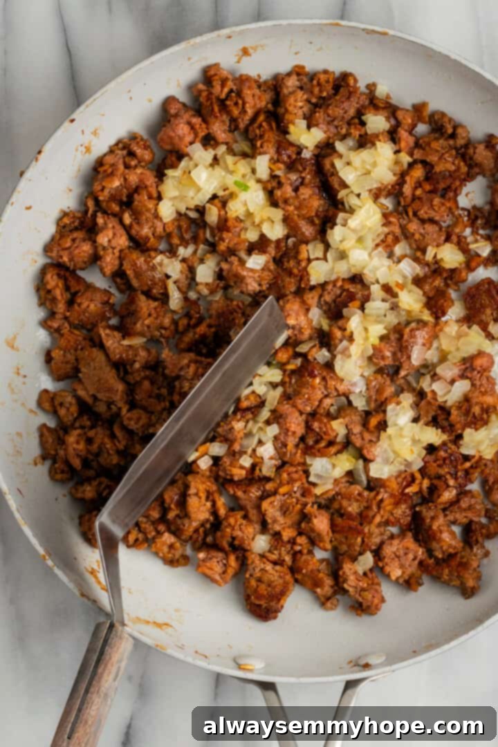 The chopped cheese sandwich is a NYC classic—and now you can make your own vegan version at home! You'll love this easy, delicious recipe. Cooking vegan ground beef with onions in a skillet