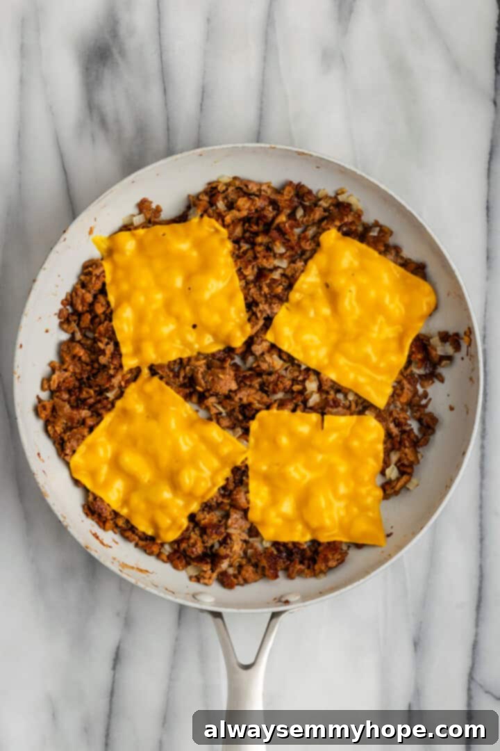 The chopped cheese sandwich is a NYC classic—and now you can make your own vegan version at home! You'll love this easy, delicious recipe. Melting vegan cheese slices on top of the cooked vegan beef and onions in a skillet