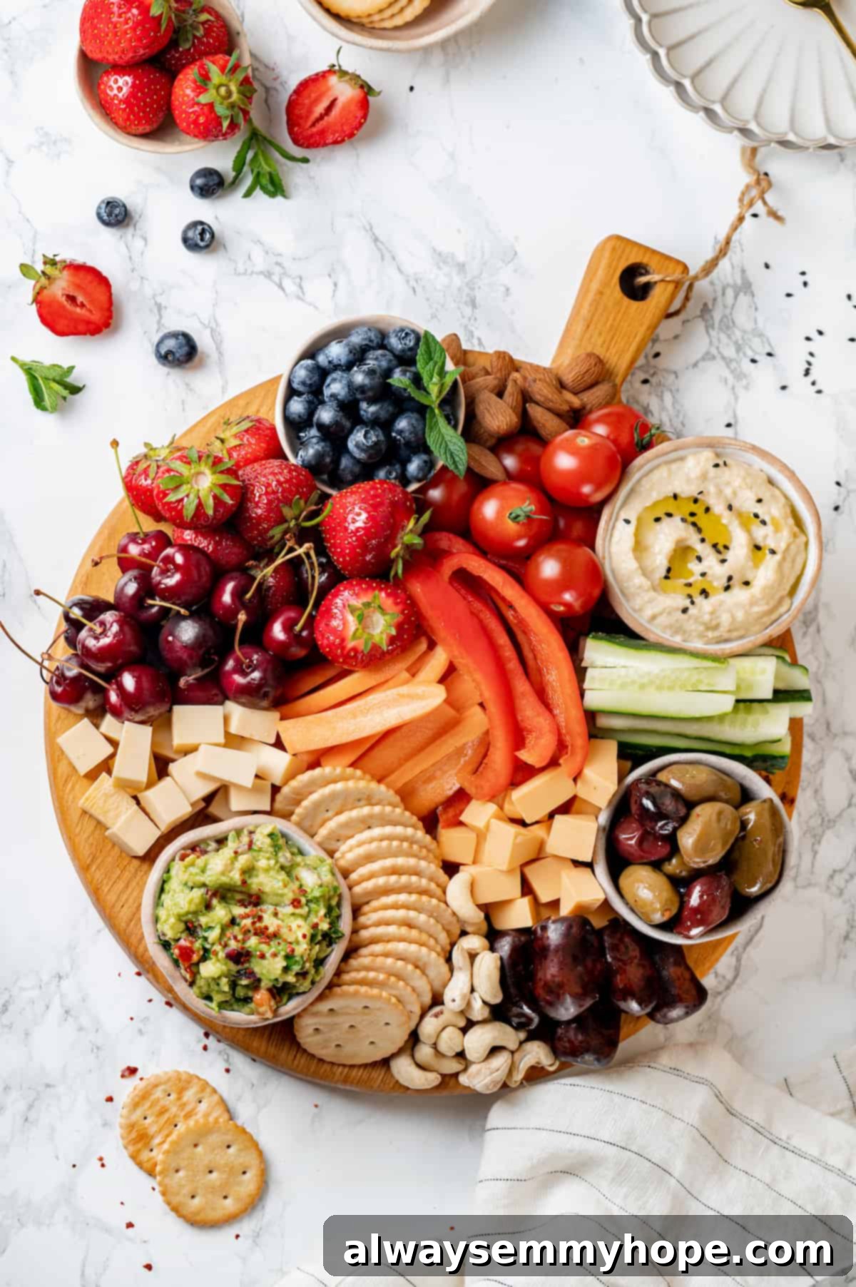 Overhead view of a vibrant Vegan charcuterie board featuring an assortment of plant-based cheese, olives, nuts, fresh fruits, and colorful vegetables, beautifully arranged.