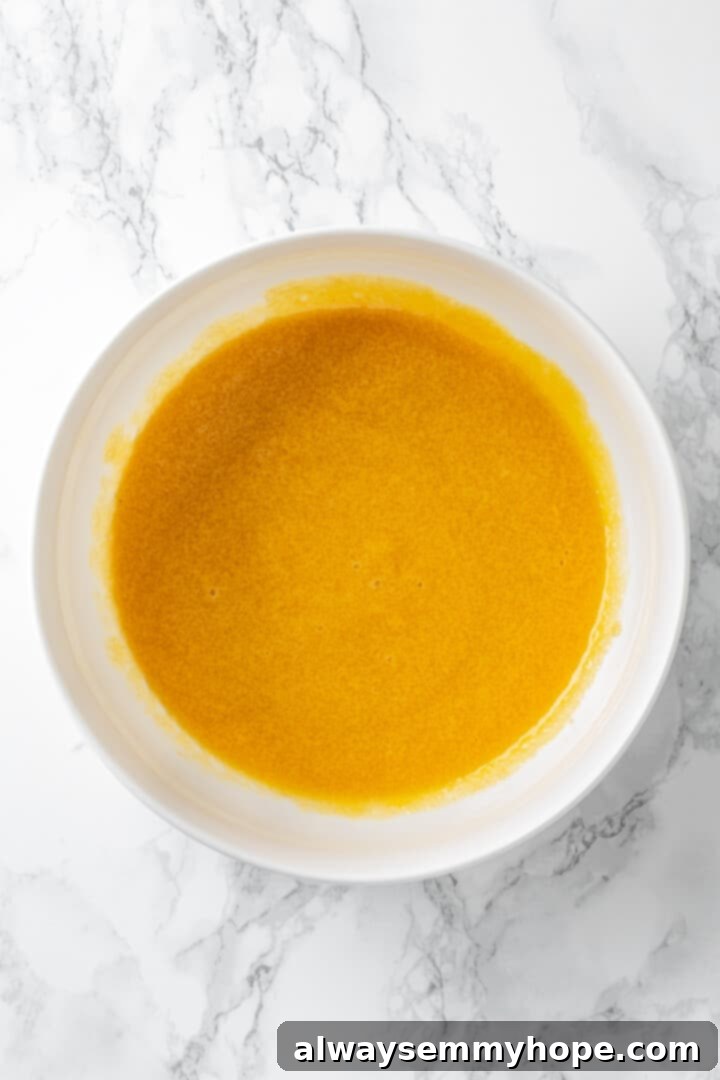 Overhead view of vegan egg and sugar mixture in bowl