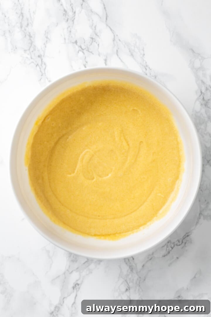 Overhead view of vegan butter, sugar, and egg mixture in mixing bowl