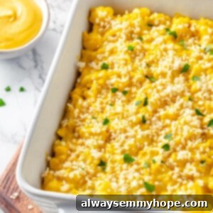 Cauliflower mac and cheese in white baking dish set on wood board