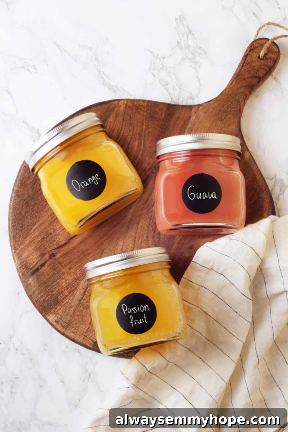 Overhead view of ingredients for POG juice: orange, guava, and passionfruit juice