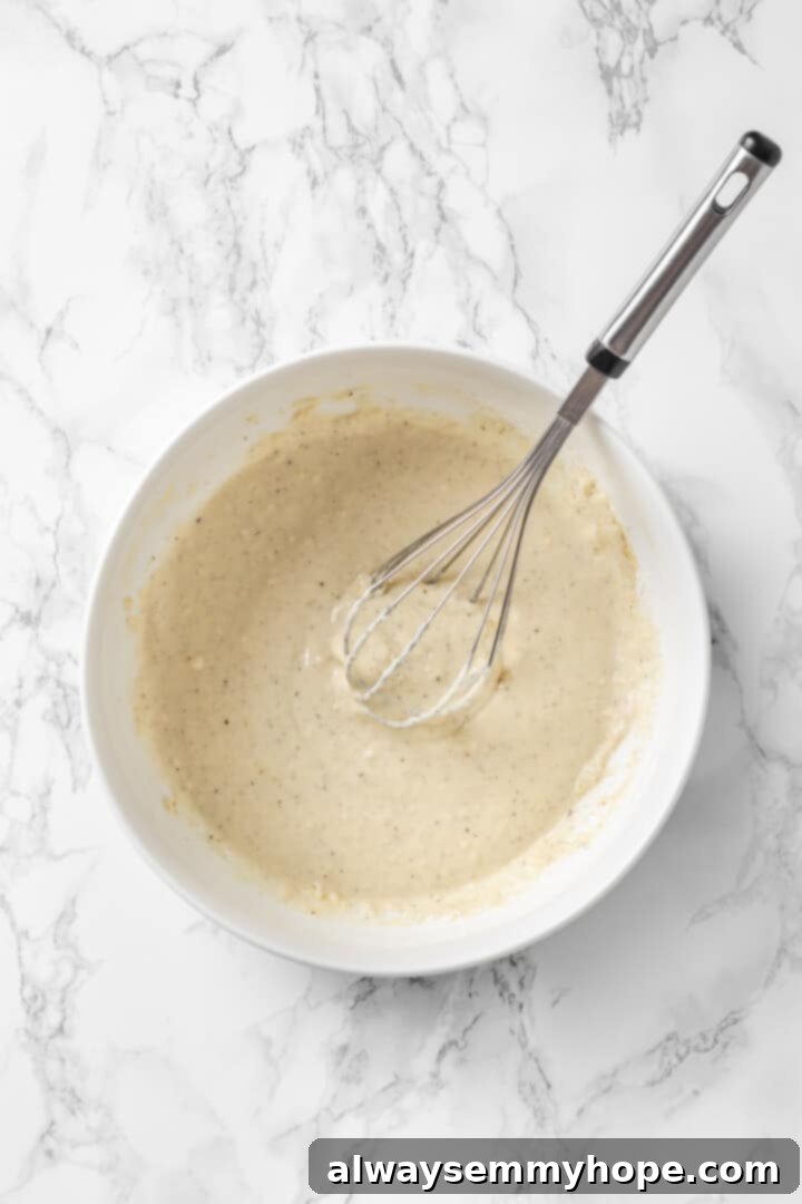 Overhead view of batter in bowl with whisk