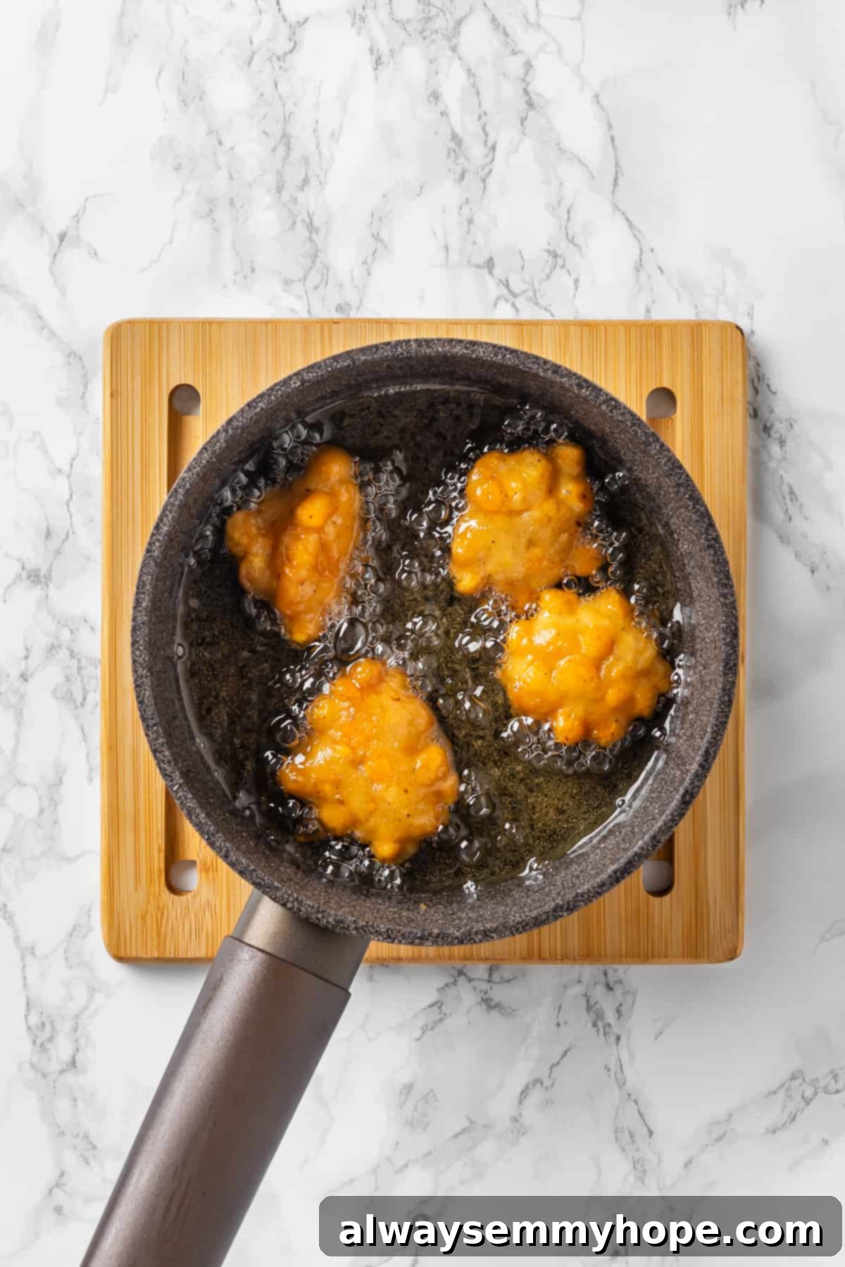 Overhead view of corn nuggets cooking in oil