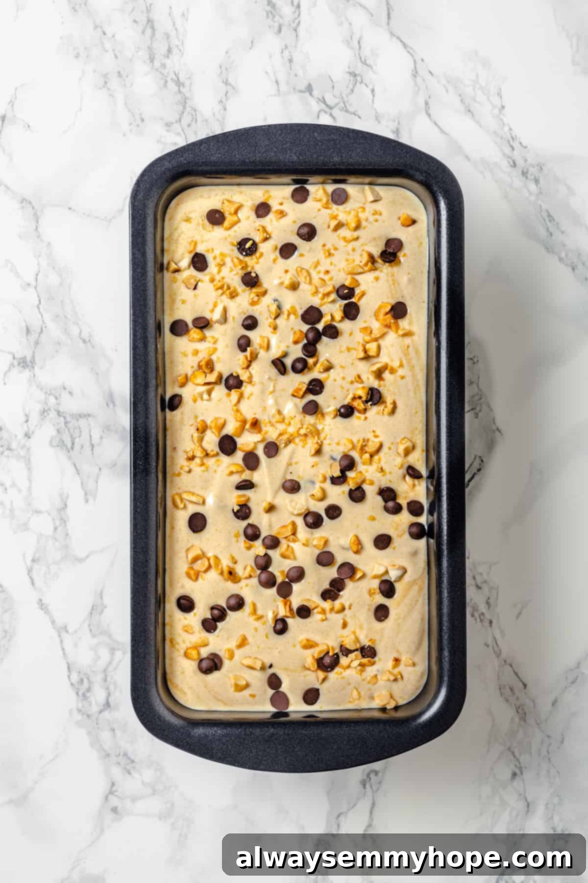 An overhead shot of the smooth and ready-to-freeze peanut butter ice cream mixture neatly poured into a loaf pan.