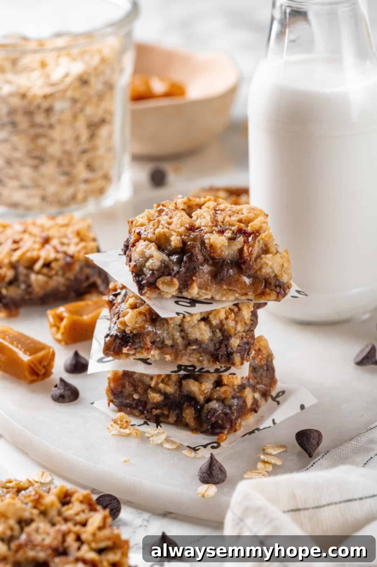 Delicious Vegan Carmelitas: Chewy Caramel, Oat & Chocolate Chip Bars Stack of 3 golden brown vegan carmelitas with visible caramel and chocolate
