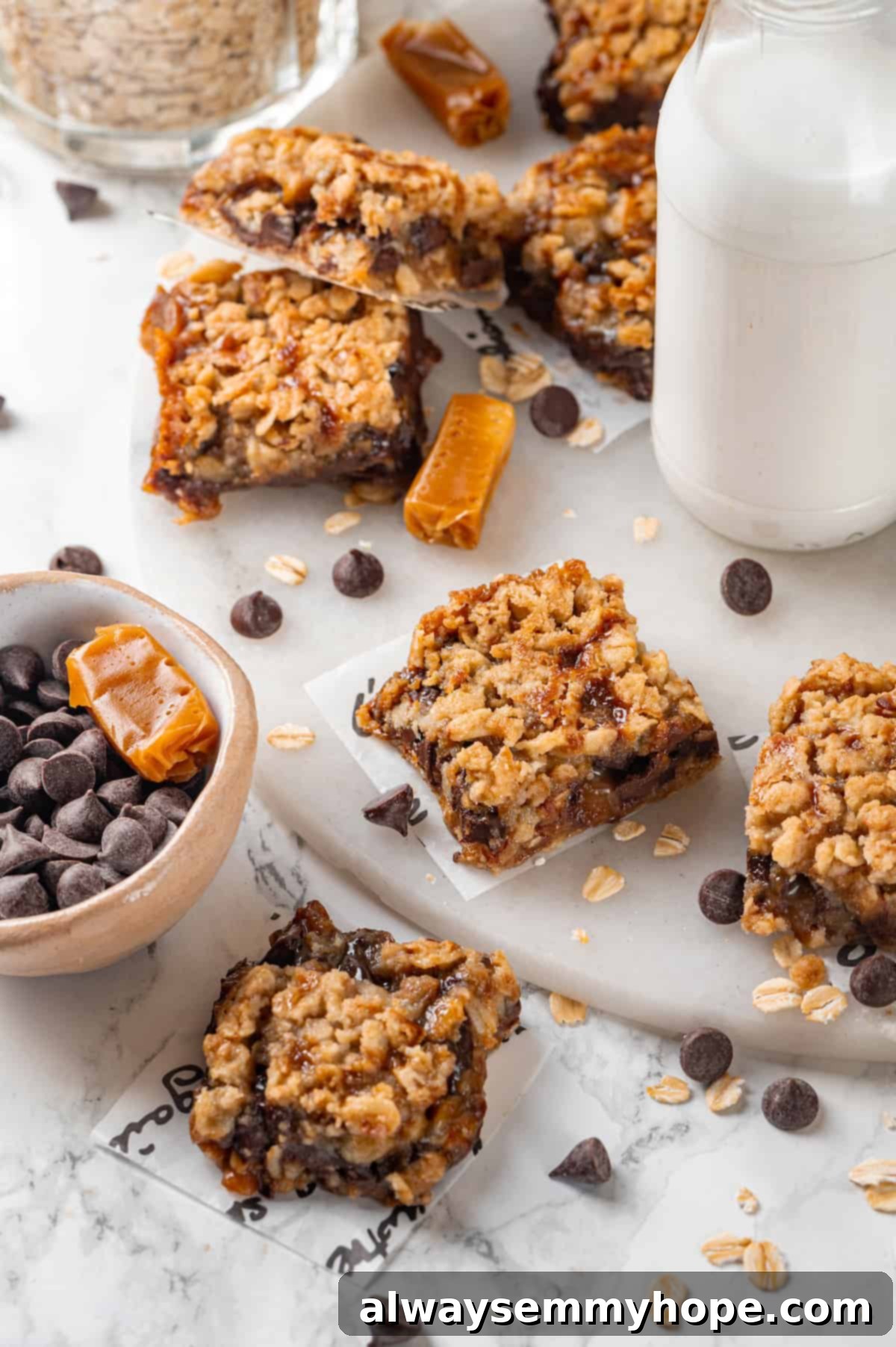 Vegan Carmelitas with Plant-Based Milk Beautifully arranged vegan carmelitas on a marble countertop with a bottle of plant-based milk in the background