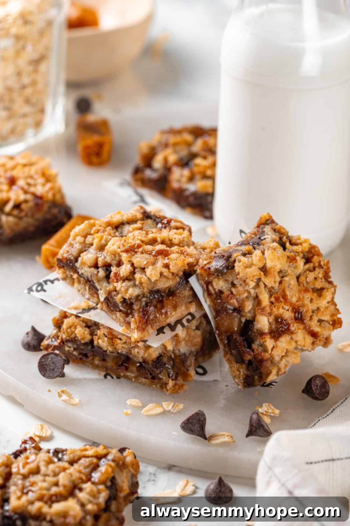 Easy Vegan Carmelitas: Perfect for Potlucks and Lunchboxes Stack of vegan carmelitas on a cutting board, with one leaning against the stack, showing rich caramel and oat layers
