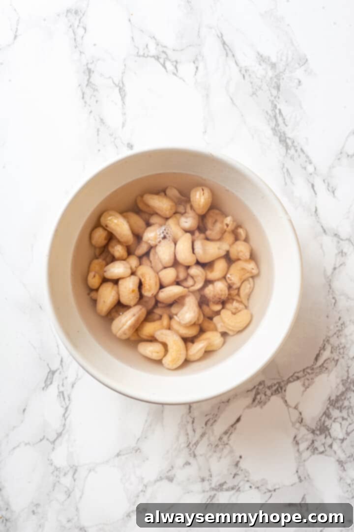 Overhead view of cashews soaking in water to soften them for the cream sauce
