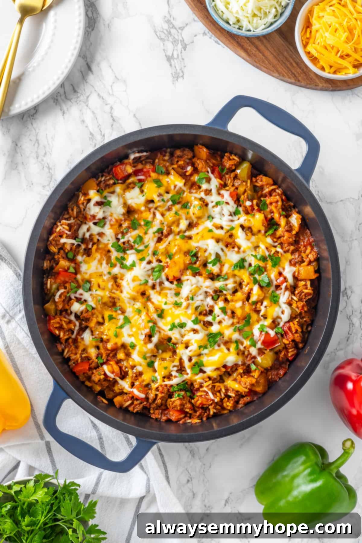 Vegan stuffed pepper casserole in a blue skillet, garnished with parsley. Overhead view of stuffed pepper casserole in blue skillet