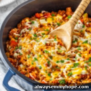 Homestyle Stuffed Pepper Bake 2 Vegan stuffed pepper casserole in skillet with wooden spoon